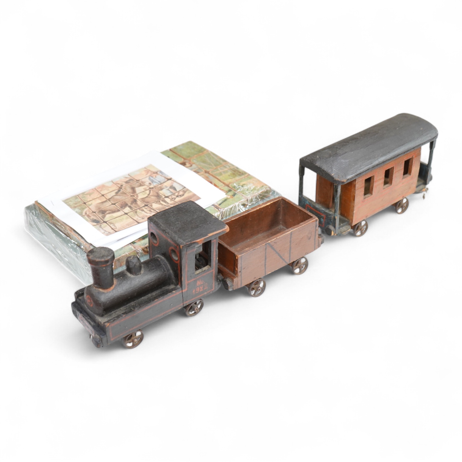 A painted wooden pull a long toy train-48cm long and two carriages, together with a painted wooden block puzzle